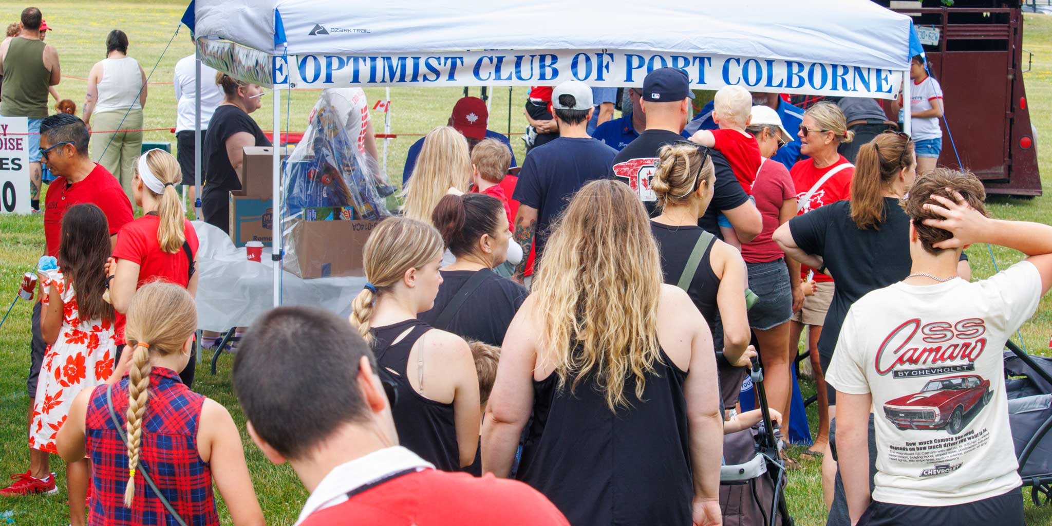 People queuing at the Port Colborne Optimist Club tent on Canada Day 2025